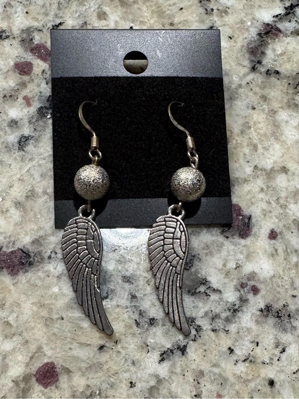 Silver tone bead and angel wing earrings